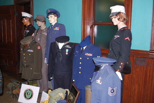 Mannequins positioned in the main waiting area, adorned with various military uniforms. 