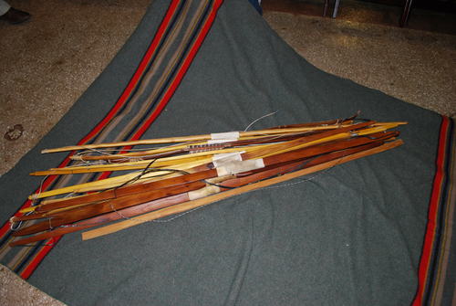 A collection of Caddo bows and a single arrow