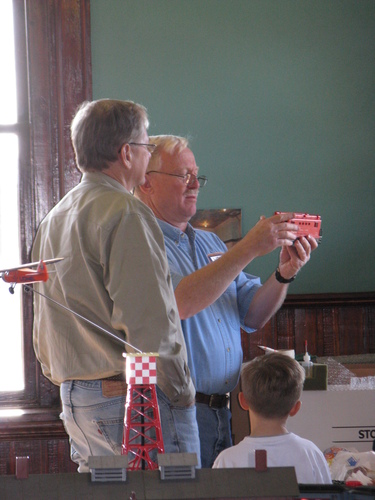 George Ellis, representing the Loblolly Model Train group, speaks to a patron about a certain railcar.
