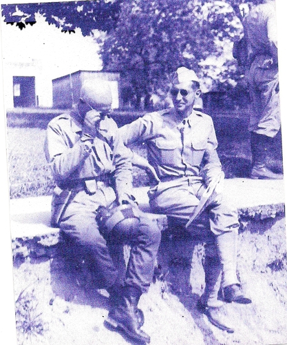 General George Patton and Lt. Colonel Mark W. Clark sitting on the sideway conferring during the Louisiana Maneuvers of 1941