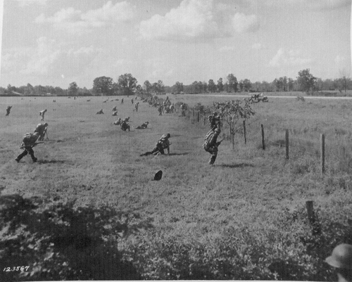 Infantry attacking across an open field during the Louisiana Maneuvers of 1941.