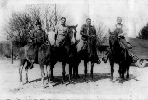 Bud, Barnie, Bobbie, and their father, Ora Robertson on their horses ready to check the cattle, horses, and other livestock on the range. Taken in 1940.