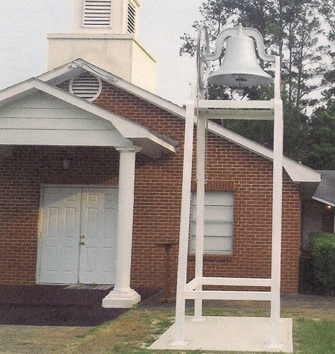 Old church bell on new mount in front of present day Pine Grove Baptist Church located in the Peason Community.