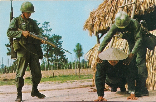 Trainees searching a villager for paperwork and weapons at Tiger Ridge Vietnam Village. (Rickey Robertson Collection)