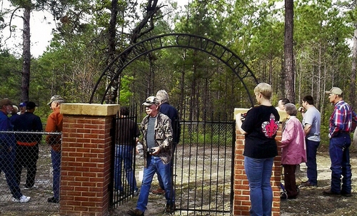 Tour group at the Merritt Cemetery. Homer Lynn Brown, a Sabine Parish native, is walking out the gate. His grandfather’s old home was near this site. (Rickey Robertson Collection)
