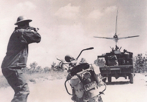Motorcycle dispatch riding engaging an attacking plane with a Thompson Submachine Gun during maneuvers. (Rickey Robertson Collection)