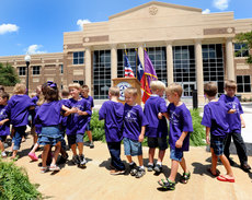Students with the Stephen F. Austin State University Charter School perform a dance during the grand-opening celebration of the new Early Childhood Research Center Sunday. Photo by Hardy Meredith 