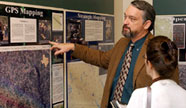 A professors showing off GPS Mapping billboard