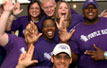 Cheerful crowd with their left hands raised