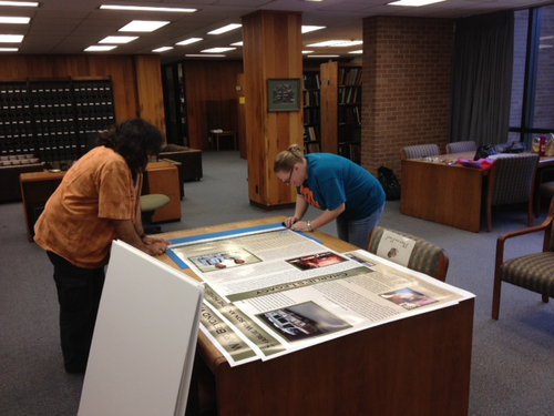 Public History graduate students Mark Musquiz and Pamela Temple working on exhibit panels