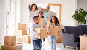 parents and children moving boxes into new home