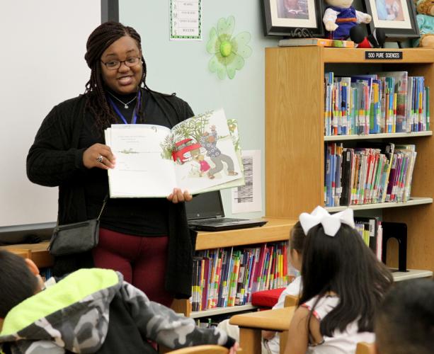 SFA senior Melanie Lynch readsto a group of Brooks-Quinn-Jones Elementary School students during the National African-American Read-In.