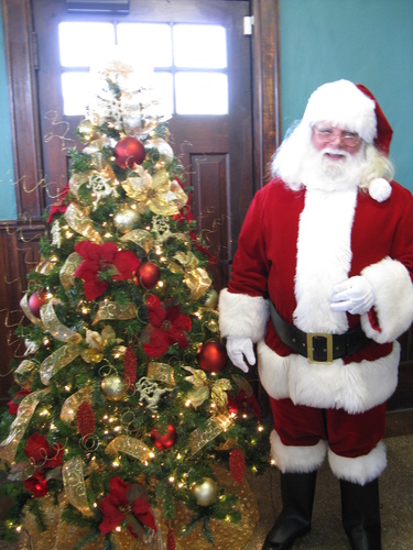 Santa Clause comes to visit the model train exhibit.