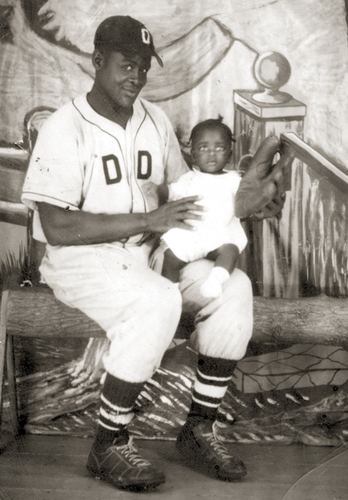 Mr. Samuels is holding his son, Curtis.