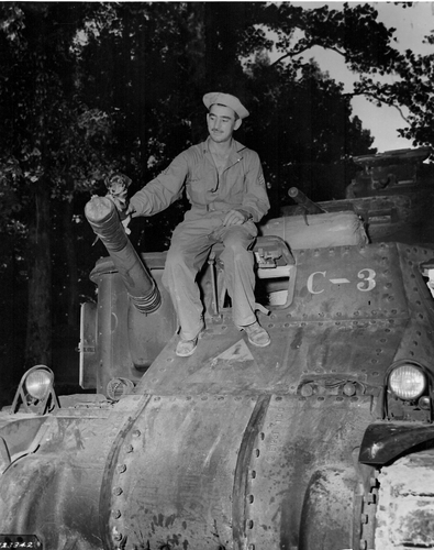 Armored crewman during the Louisiana Maneuvers of 1941 holding his pet, a little puppy.