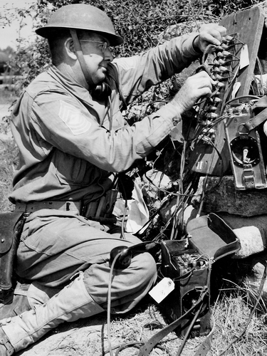 Communications sergeant preparing communication equipment during the Louisiana Maneuvers of 1941