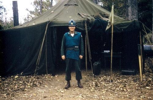 An Aggressor soldier camped near Peason, Louisiana during Exercise Sage Brush. Aggressor troops wore pale green best over their uniforms, and had an attachment on top of their helmets to denote them from other troops (Rickey Robertson Collection)