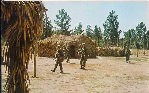 Trainees on patrol through Tiger Ridge Vietnam Village. Note the thatched huts. (Rickey Robertson Collection)