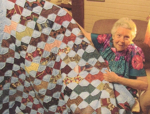 Sylvia Evans Brown pictured with the beautiful handmade quilt she made using neckties. (Rickey Robertson Collection)