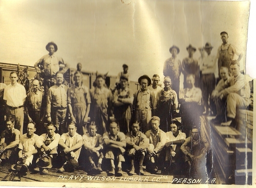 Millworkers having their photo taken at the Peavy Wilson Lumber Co. mill with Thurm Boring, Peason City Marshal. He is pictured in suit coat and hat on left in second row. (Rickey Robertson Collection)