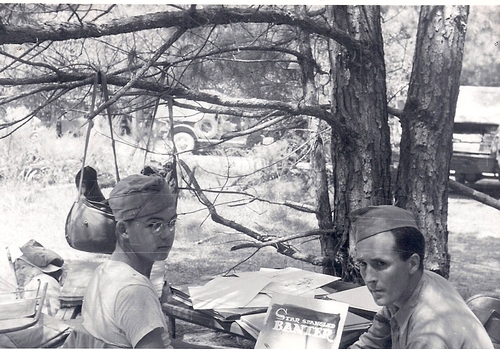 Pvt. Bill Mauldin, pictured left in glasses, was in the 45th Infantry Division during the La. Maneuvers. His friend is holding his first published book Star Spangled Banter in their camp near DeRidder, La.