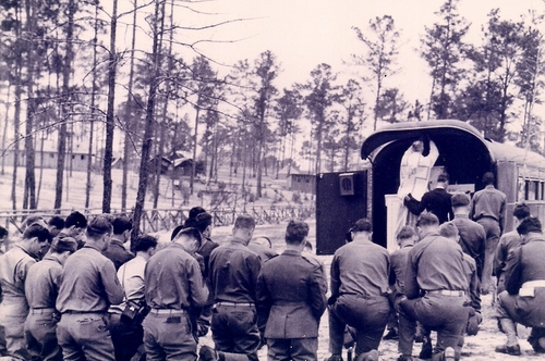 Divine Services being conducted by a Chaplain in the field at Camp Beauregard during World War II maneuvers. (Rickey Robertson Collection)