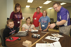 Dr. Dan Bruton (right), astronomer and professor in the SFA Department of Physics and Astronomy, leads iMAS Academy participants in a robotics experiment.