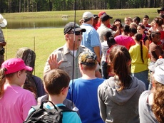Jeff Cox, game warden with Texas Parks and Wildlife, speaks to participants in the inaugural KidsFish event at the Stephen F. Austin State University Piney Woods Conservation Center. Game warden Johnny Jones is also pictured.