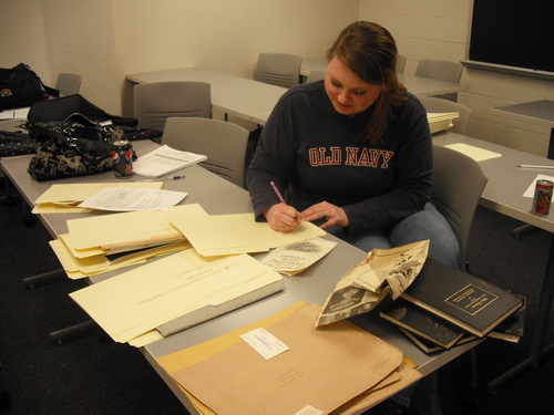 Joy Pitts examining materials from Millard's Crossing