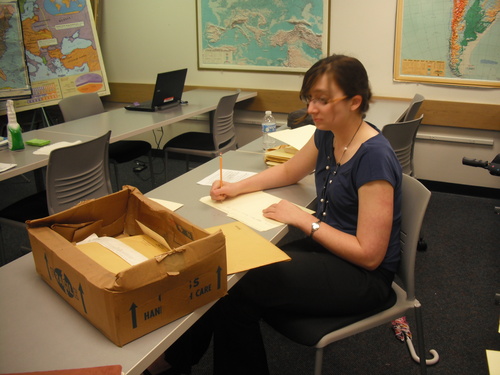 Cassie Bennett examining materials from Millard's Crossing