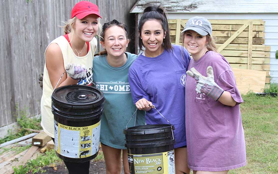 SFA students painting as part of a community service project