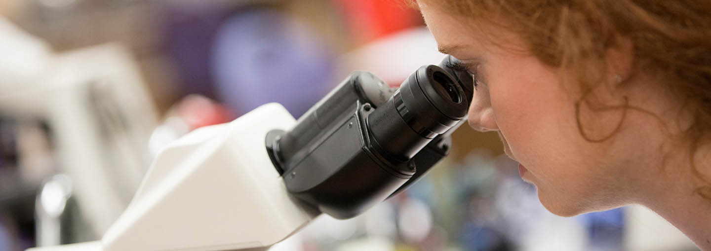 SFA student using microscope