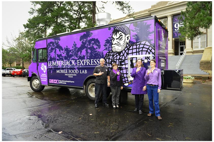  Hospitality administration faculty members Todd Barrios, chef; Dr. Chay Runnels, program coordinator and associate professor; Dr. Mary Olle, assistant professor; and Donna Fickes, clinical instructor, are pictured alongside the mobile food lab. 