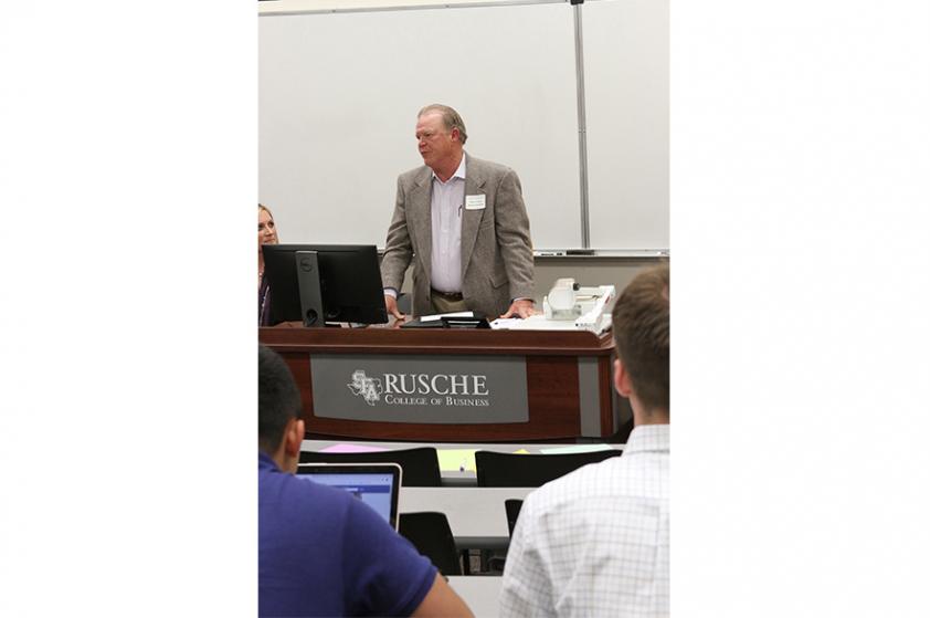 Mitch Fralick, a retired executive from Wood Group PSN and Stephen F. Austin State University alumnus, discusses international business with students during the sixth annual College to Career Conference, which was hosted by SFA’s Rusche College of Business.