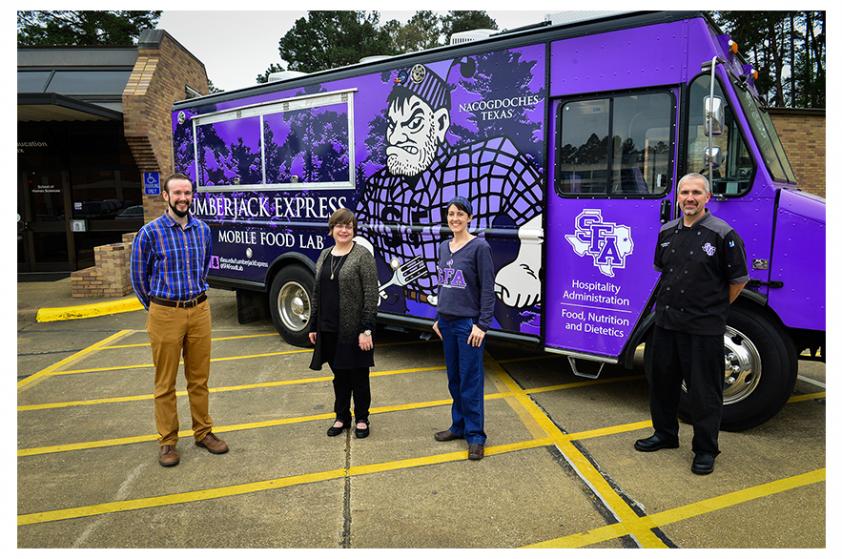 SFA faculty members Justin Pelham, clinical instructor; Dr. Chay Runnels, hospitality administration program coordinator and associate professor; Dr. Donna Fickes, clinical instructor; and Todd Barrios, chef instructor, with the Lumberjack Express mobile food lab.