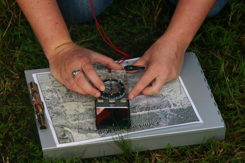 a student performs mapping fieldwork 