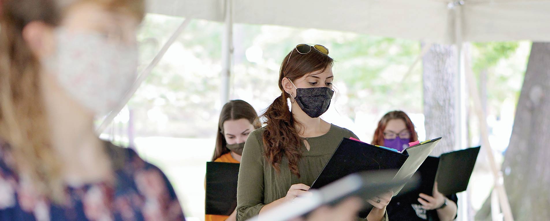 Music students, including graduate student Taylor Davis, practice outdoors underneath a tent to help ensure appropriate physical distancing. Photo by Robin Johnson