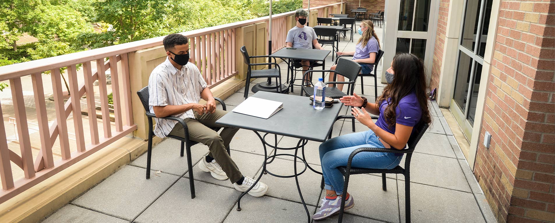 Students visit on the balcony overlooking the Baker Pattillo Student Center Plaza. Face coverings are required to be worn in public areas inside buildings and outside when maintaining a physical distance of at least 6 feet is not possible. Photo by Hardy Meredith