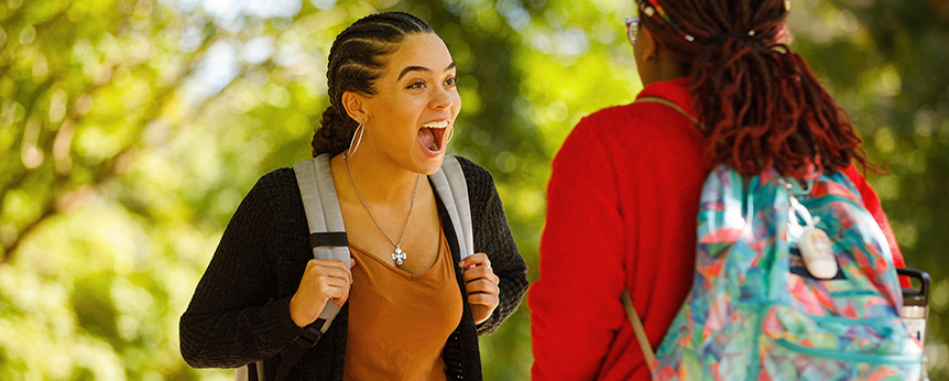 two female students in excited conversation