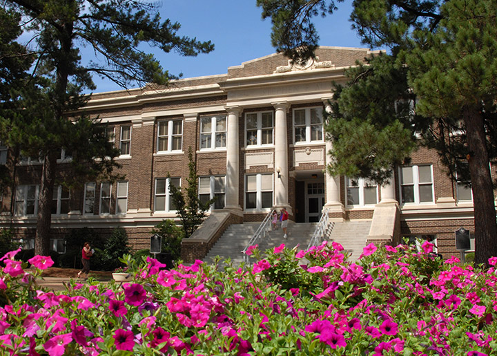 Austin building in the spring with pink flowers in the foreground