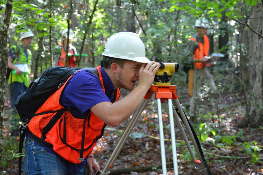 student using equipment at forestry field station