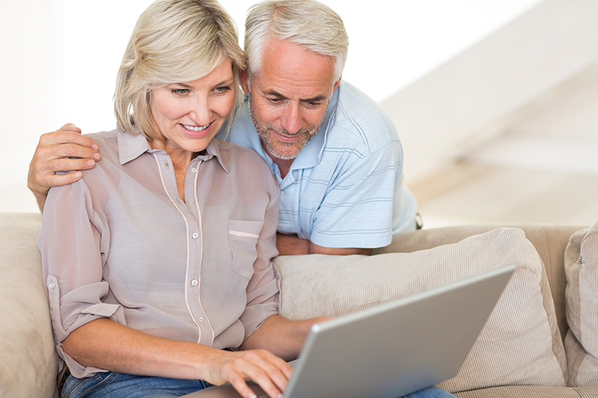 mature couple looking at laptop