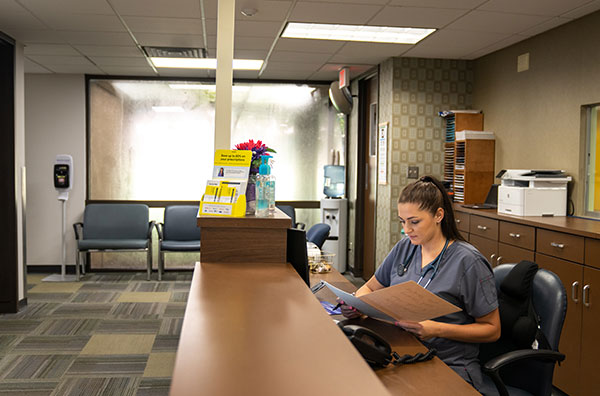 Waiting room of the hub with nurse reviewing patient file