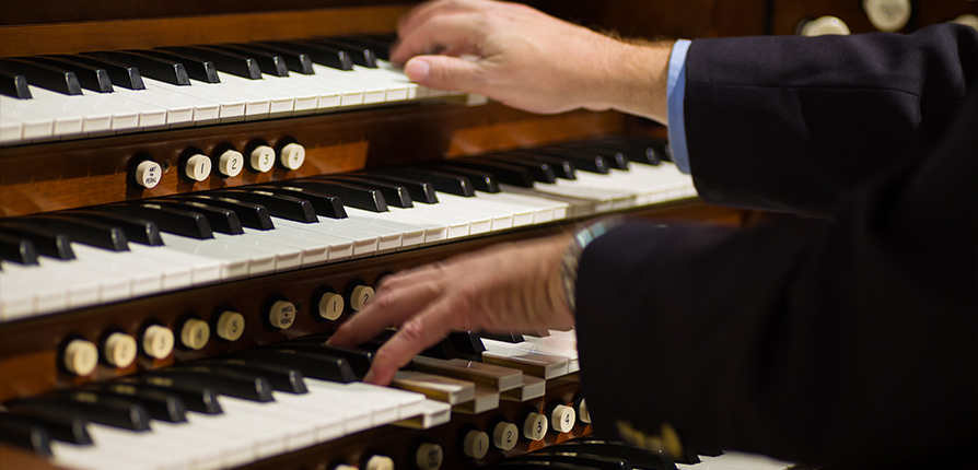 stock image of person playing organ