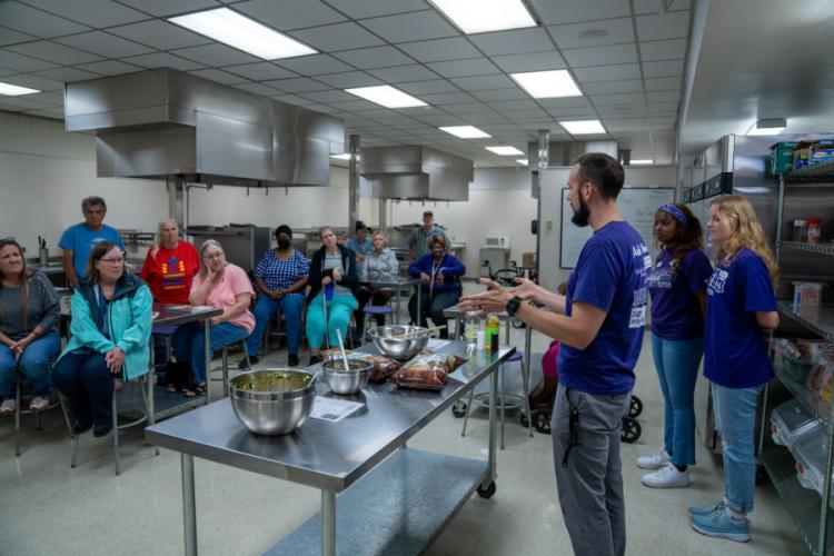 Community members engage with hosts of the Cooking Matters program