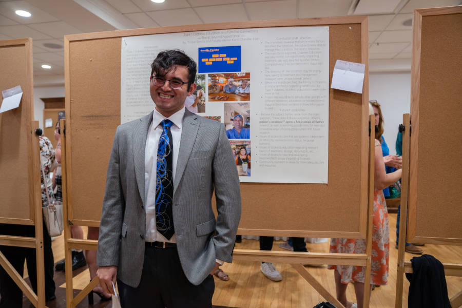 A student presents during the poster segment of the Undergraduate Research Conference.