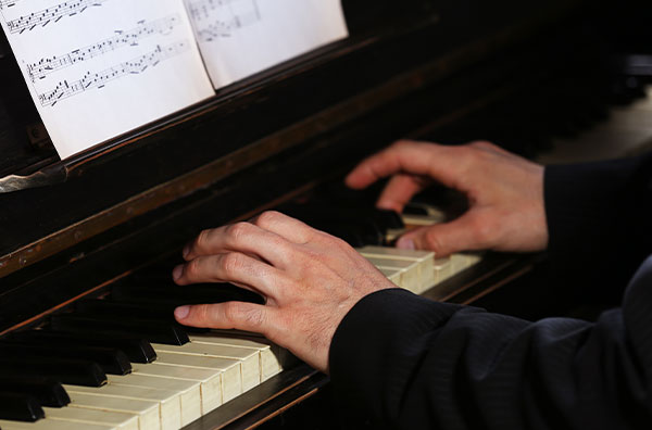 Closeup of male fingers on piano keys