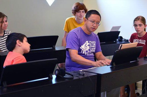 Instructor teaching keyboarding to students