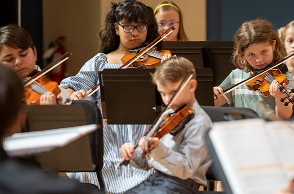 Students performing and playing violin