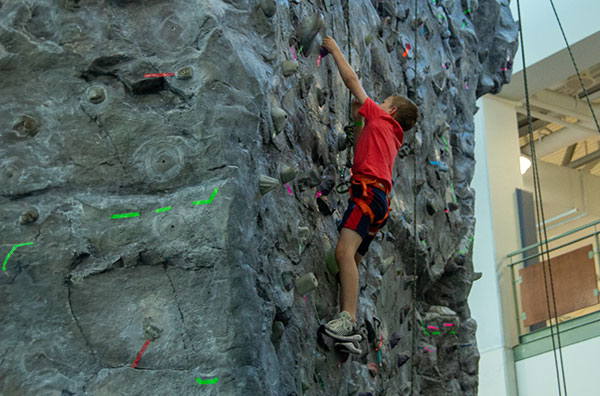 Child climbing rock wall